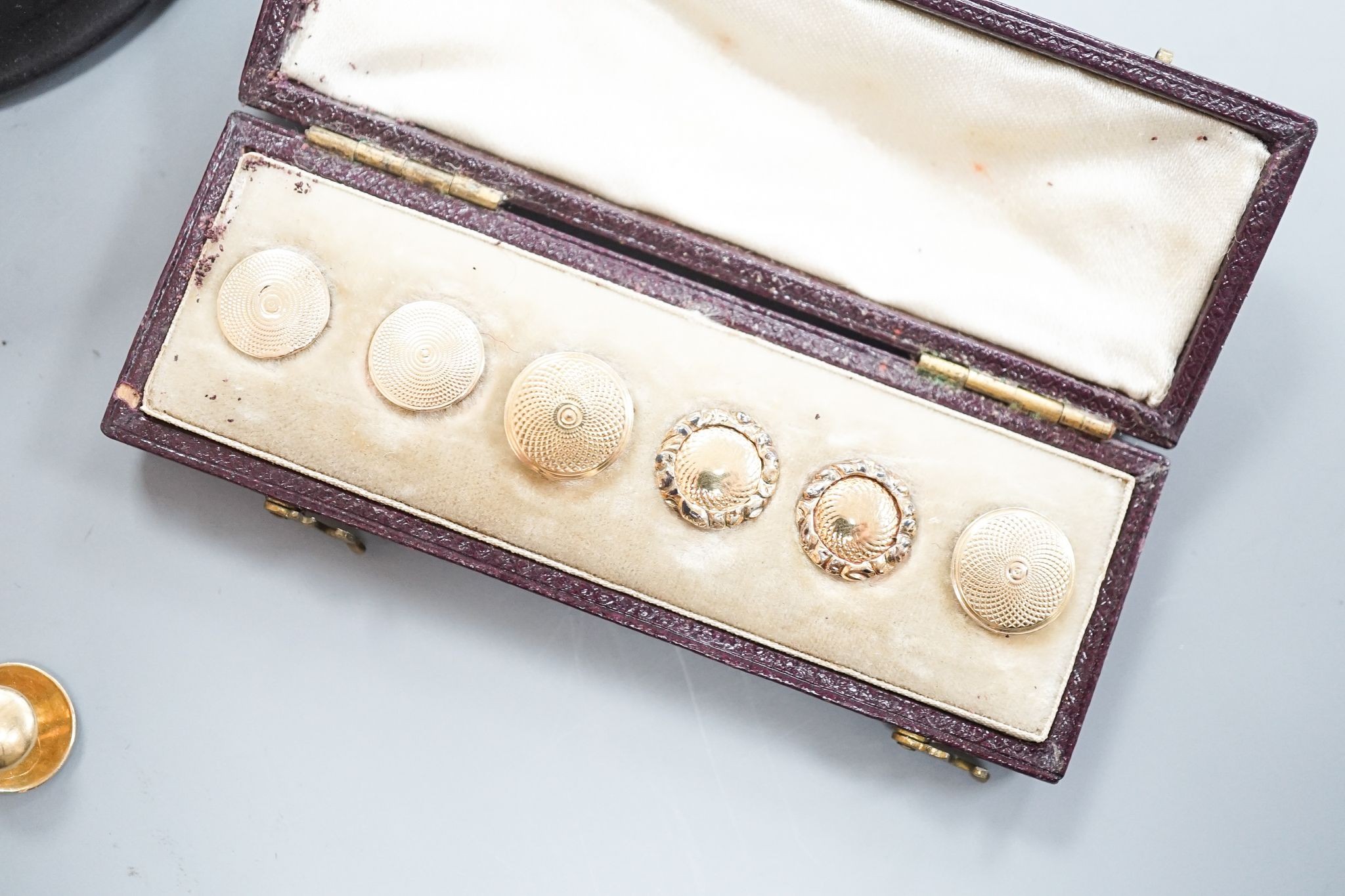 A yellow metal signet ring(a.f.) 7.1 grams, four assorted yellow metal dress studs stamped 18, 7 grams, one other stud stamped 15, 1.2 grams, a 9ct and gem set stick pin, gross 0.6 grams and six cased yellow metal studs.
